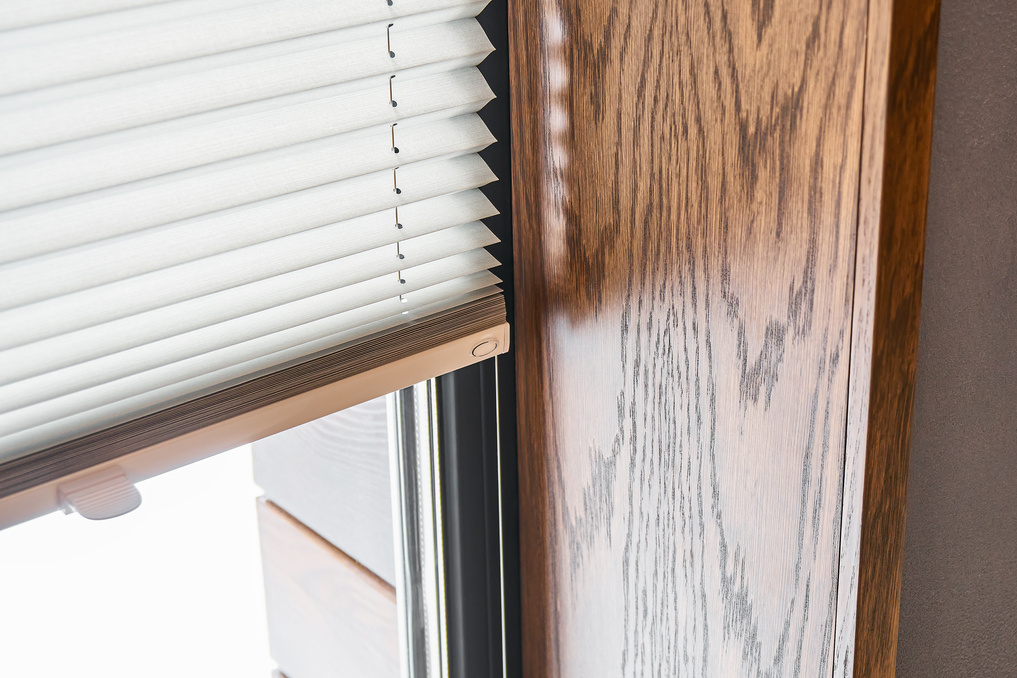 Wooden slopes on the window. Window with pleated shades